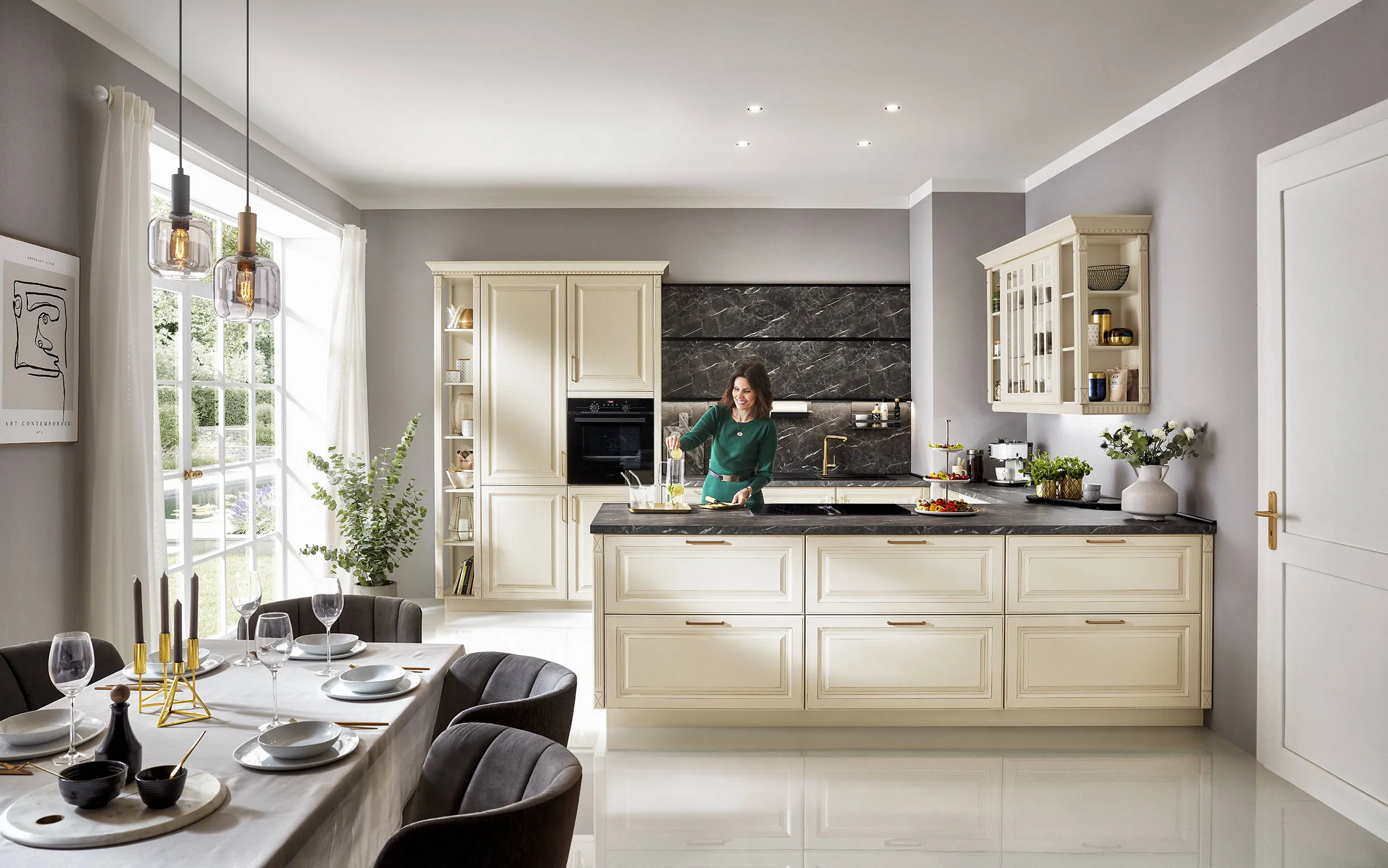 Classic cream kitchen with traditional cabinetry, modern black marble accents, and a dining table set with elegant dinnerware in a bright and airy space. Classic cream kitchen with traditional cabinetry, modern black marble accents, and a dining table set with elegant dinnerware in a bright and airy space.