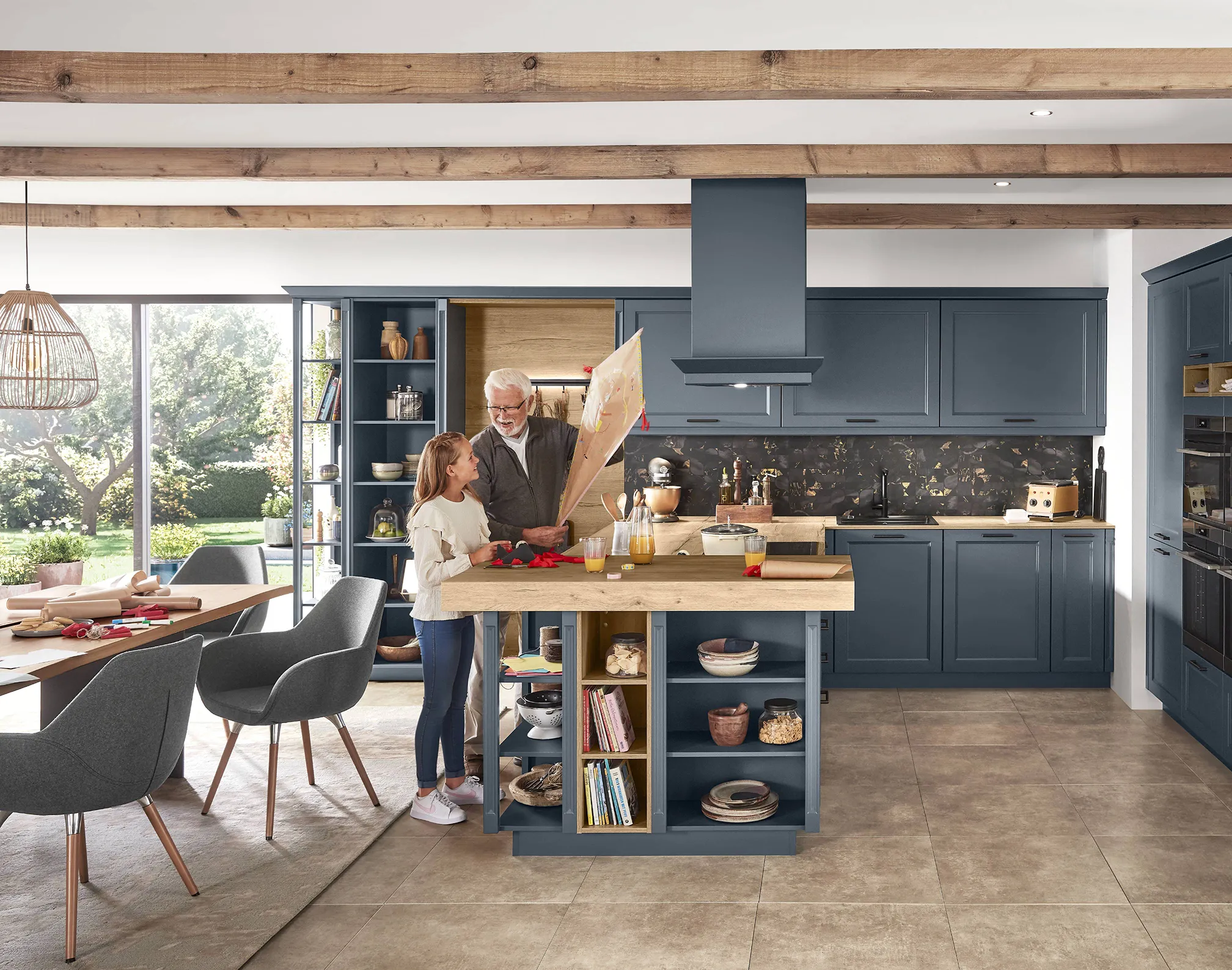 Modern kitchen design with vintage elements, including dark blue cabinetry, natural wood finishes, and exposed ceiling beams, featuring a grandfather and granddaughter working on crafts. Modern kitchen design with vintage elements, including dark blue cabinetry, natural wood finishes, and exposed ceiling beams, featuring a grandfather and granddaughter working on crafts.