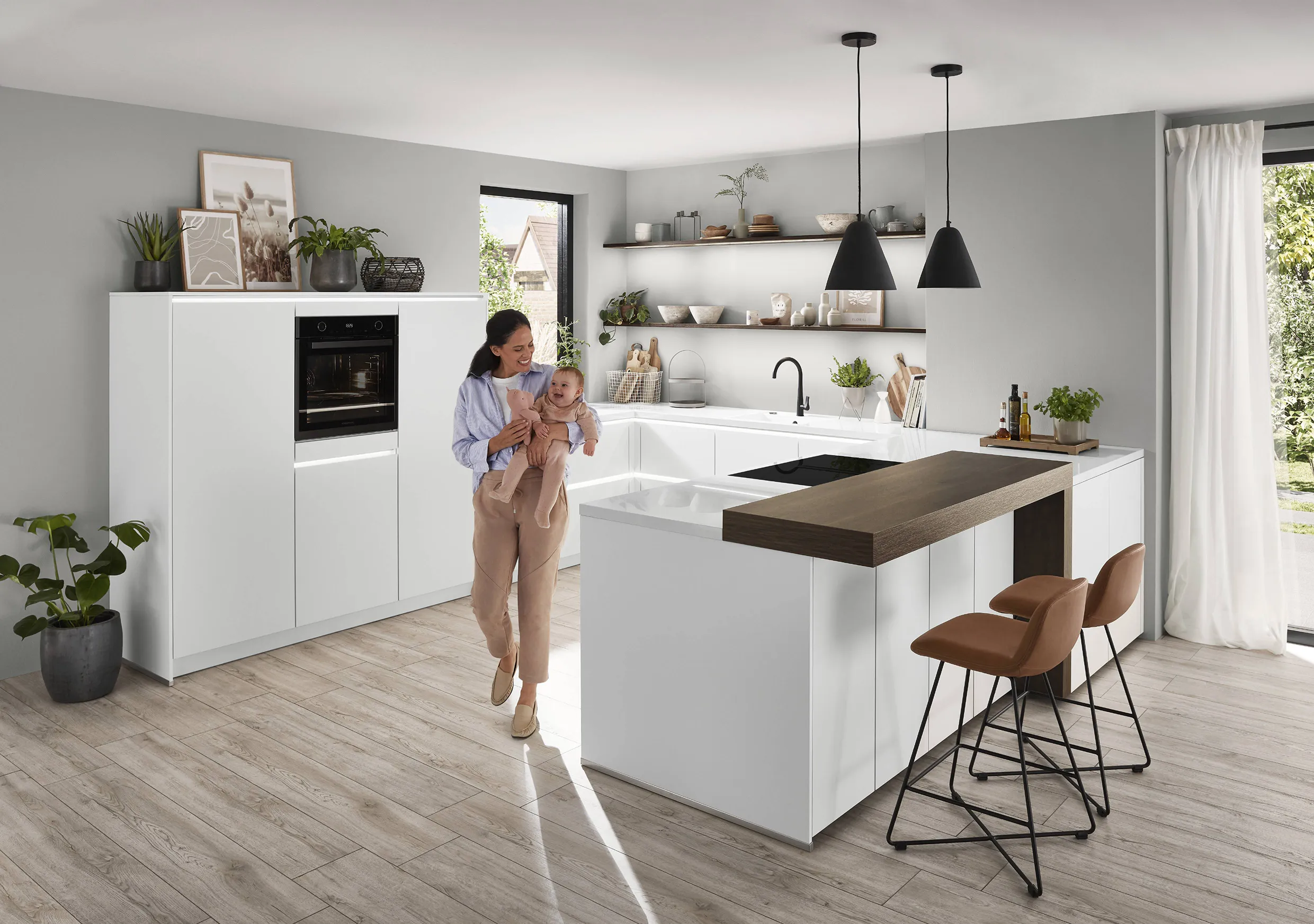 Modern white kitchen with a sleek island and integrated sink, featuring warm wood accents and natural lighting. Modern white kitchen with a sleek island and integrated sink, featuring warm wood accents and natural lighting.