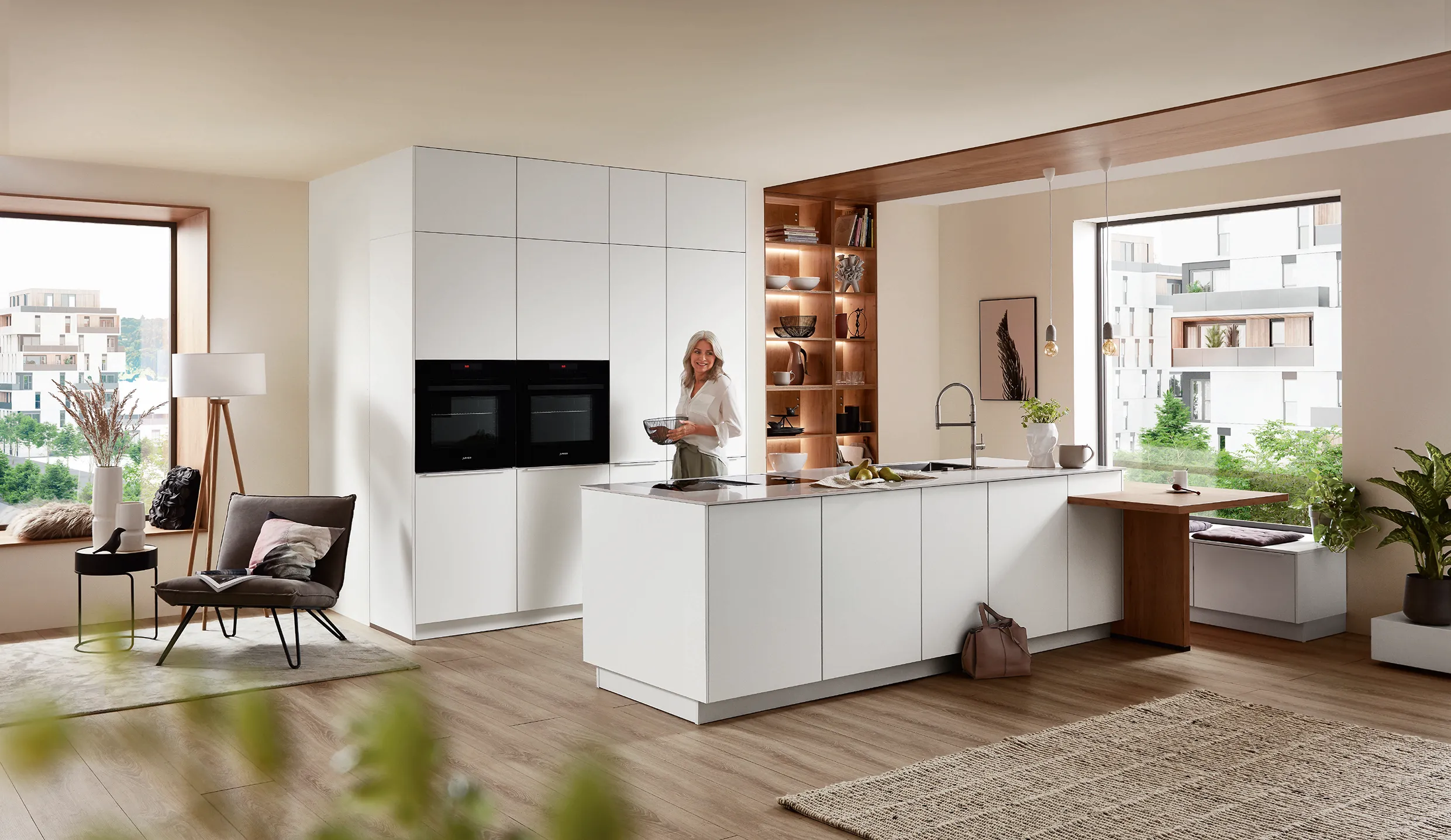 Bright, modern kitchen with white cabinetry and wood accents, featuring a spacious open layout for durability and contemporary style. Bright, modern kitchen with white cabinetry and wood accents, featuring a spacious open layout for durability and contemporary style.