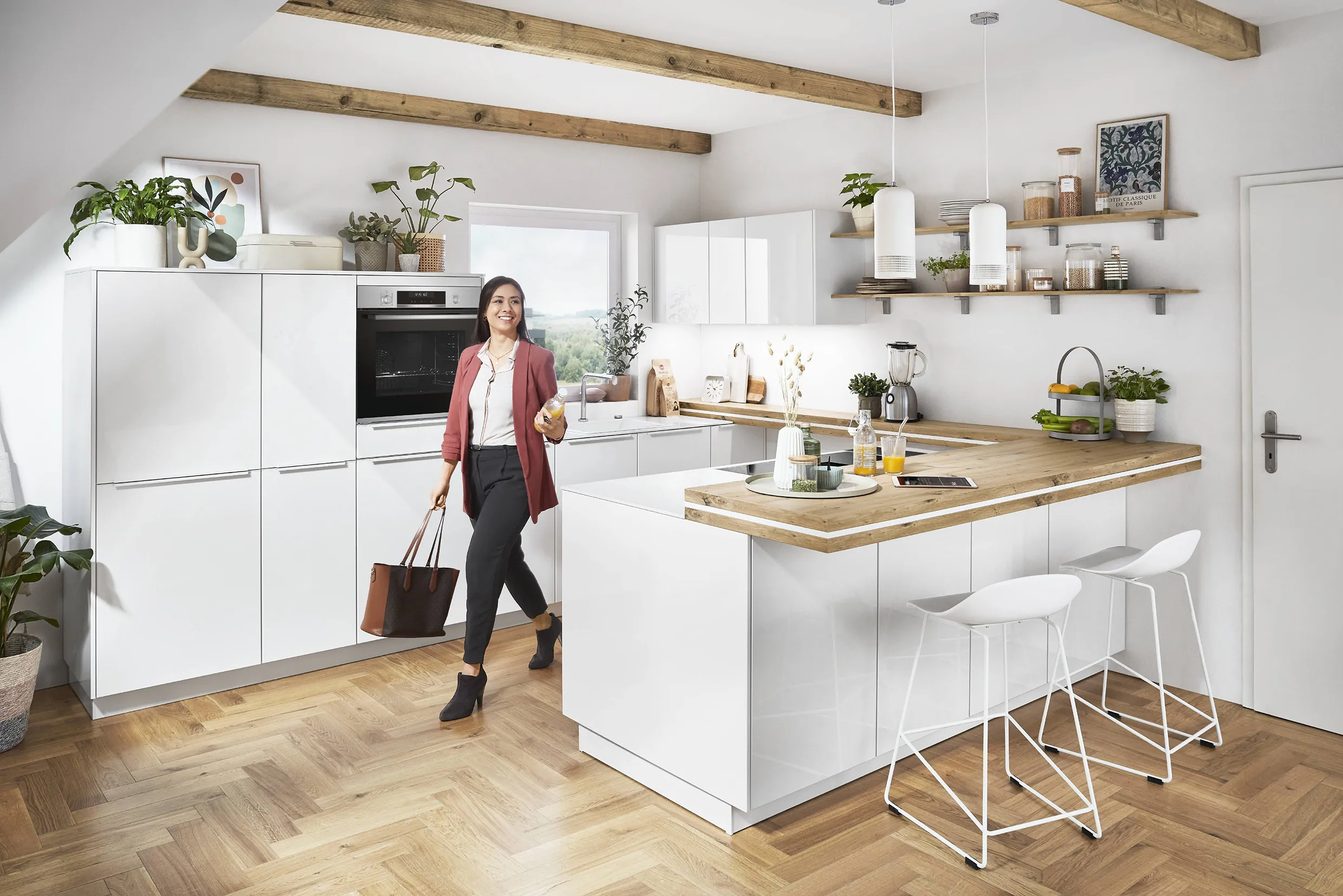 Woman entering a bright kitchen with white cabinets and wooden countertops, featuring Scandinavian design with natural light and minimalist open shelving. Woman entering a bright kitchen with white cabinets and wooden countertops, featuring Scandinavian design with natural light and minimalist open shelving.