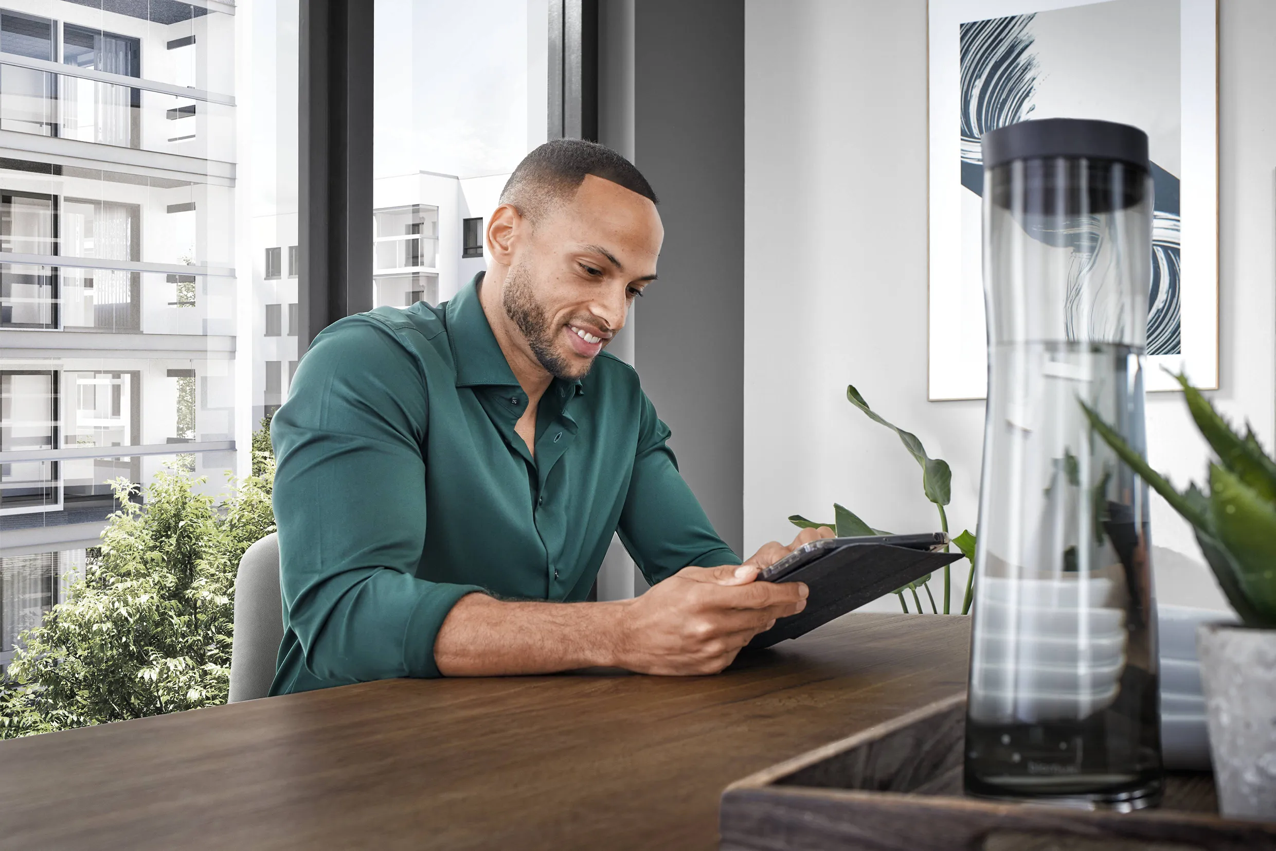 Man using a tablet in a bright, modern home office, showcasing the integration of AI technology into everyday life. Man using a tablet in a bright, modern home office, showcasing the integration of AI technology into everyday life.