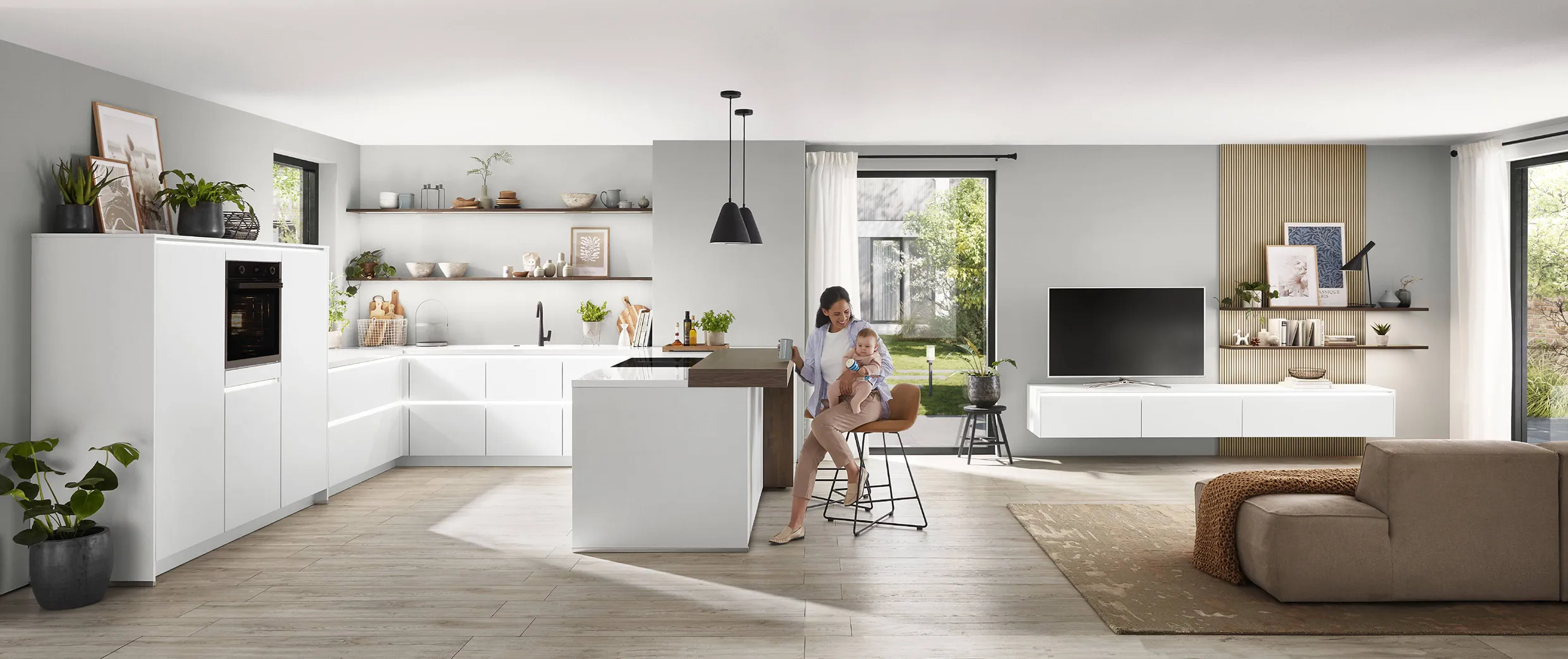 Mother and child in an open-plan kitchen with white cabinets and wooden accents, showcasing a seamless design with minimalistic decor and natural light. Mother and child in an open-plan kitchen with white cabinets and wooden accents, showcasing a seamless design with minimalistic decor and natural light.