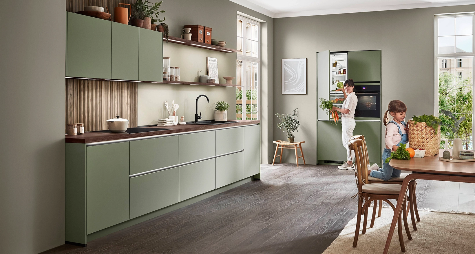Mother and daughter in green handleless kitchen Mother and daughter in green handleless kitchen